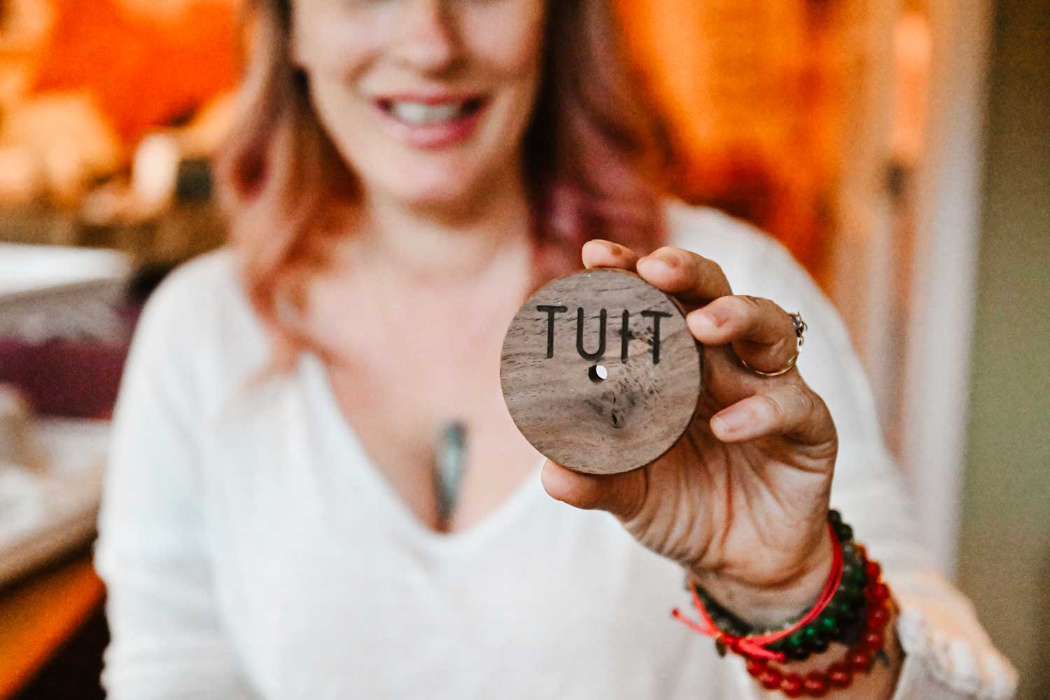 a woman holding a round "tuit"